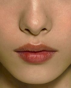 a close up shot of a woman's face with her eyes closed and lips slightly open