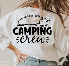 a woman wearing a white sweatshirt that says camping crew with a crochet hook on it