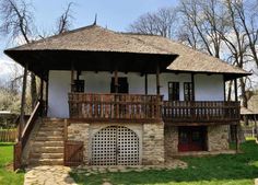 an old style house with a thatched roof and wooden balconies on the second floor