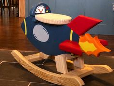 a wooden toy airplane with a clock on it