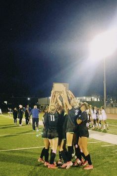 the girls soccer team huddles together on the field to celebrate their win over person