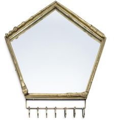 a mirror hanging on a wall with hooks attached to the side and an ornate gold frame