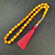 ⭐️ Tasbih is completely handmade & masterwork. ⭐️ Special capsule cut and wavy yellow color bakelite beads. ⭐️ It has perfectly handcrafted rope tassel.  ⭐️ 100% Brand New Condition. ℹ️ About Material; Faturan & Bakelite (Catalin) is artificial resin in its simplest definition. It is an artificial imitation of real amber, that is, petrified pine tree resin. Catalin was produced to replace natural amber due to its very expensive and fragile nature. The most important feature is that it is extreme Rope Tassel, Worry Beads, Natural Amber, Prayer Beads, Yellow Color, Rosary, Beaded Jewelry, Amber, Charms