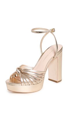 PRICES MAY VARY. Leather sole Metallic finish, Knot at front, Open toe Heel: 4.25in / 110mm, Platform: 1in / 25mm Buckle ankle strap Platform profile Striking metallic leather composes these occasion-worthy Loeffler Randall sandals, which feature a strappy upper, a substantial platform, and a block heel. Gold Thick Heels, Prom Shoes, Loeffler Randall, Platform Heel, Thick Heels, Metallic Leather, Platform Heels, Platform Sandals, Wedding Shoes