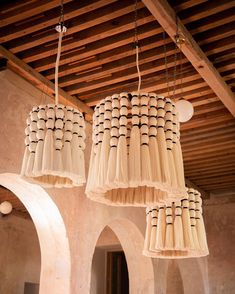 three chandeliers hanging from the ceiling in a room