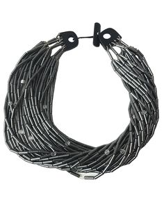 Hematite is more silver than black. This necklace has accent faceted crystals, making an even more lustrous combination with the silver color of the Hematite. The necklace has 24 Hematite strands, one crystal in each strand, and a natural Onix toggle clasp.

The shortest strand, or the closest to the neckline, measures (+/-) 19 IN, and the longest measures (+/-) 24 IN. The necklace weighs 20 OZ. There are several ways to display its splendor: flat, twisted, crossing strands, and wearing the clasp at the front or back of the neck. Agate Stone Necklace, Hematite Necklace, Natural Stones Necklace, Coral Necklace, Faceted Crystal, Toggle Clasp, Agate Stone, Stone Necklace, Silver Color