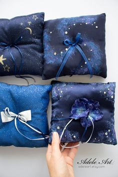 three blue pillows with bows tied around them