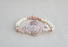 This beautiful rose gold bridal bracelet I created using the most fabulous Rose Gold plated Swarovski Pure brilliance cubic zirconium component that is so full of sparkle and features tons of cz stones in different shapes and sizes. Finished with one strand of Swarovski pearls. Bracelet measures 6.5 inches and extends to 8 inches with an extension chain and has a lobster clasp closure. CZ pendant measures 2.25 x 1 inch. This is an original design by © Treasures by Agnes PLEASE ALLOW APPOX 10 DAY Adjustable Rose Gold Pearl Bracelet For Wedding, Adjustable Rose Gold Beaded Bracelet For Wedding, Rose Gold Beaded Bangle Bracelets For Wedding, Rose Gold Crystal Bracelet For Wedding, Bridesmaid Pearl Bracelet, Gold Bracelet Wedding, Swarovski Pearls Bracelet, Bridal Bracelet Pearl, Bride Bracelet