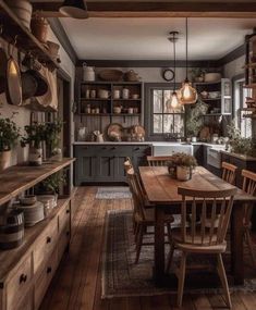 a kitchen with wooden floors and lots of pots on the shelves above the counter top