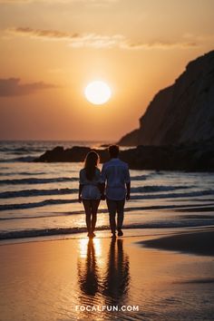 Couple walking on the beach at sunset, walking at the water's edge towards the sunset and cliffs behind. Couple Poses In Sea Beach, Beach Photo For Couples, Beach Pics For Couples, Couple Shoot On Beach, Beach Poses Couples Photo Ideas, Couple Photo Shoot Beach, Couples Sunset Photoshoot Beach Photos, Couple Photos On Beach, Couple Pictures On The Beach