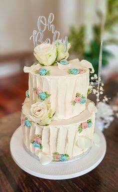 a three tiered cake with flowers on it