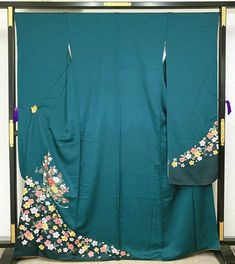 This furisode (long-sleeved kimono) has cherry blossoms, chrysanthemums, and plum blossoms on a dark green background. The peonies on the front are embroidered. The simple pattern changes the atmosphere depending on the obi and accessories, so you can coordinate it to your own taste in a wide range of ways, such as a simple one-tone coordination or a trendy lace coordination. Length from sleeve to sleeve: 68 cm Length (from the shoulder): 168 cm Sleeve width: 34 cm Sleeve length: 114.5 cm Front width: 24.5 cm Back width: 30cm Stitching on body side: 1.5cm Sleeve side: 1.5cm Inner fly width: 6cm Material: Pure Silk Condition:Please see photos. Thank you for visiting my page. My store owns a lot of unique items that you won't see in other stores. You won't regret it! ☆ Furisode" symbolizes y Floral Print Long Sleeve Kimono For Wedding, Long Sleeve Floral Print Kimono For Wedding, Long Sleeve Floral Kimono For Wedding, Long Sleeve Floral Print Wedding Kimono, Spring Wedding Green Kimono, Long Floral Embroidered Kimono For Wedding, Green Long Kimono For Wedding, Long Sleeve Kimono, Plum Blossoms