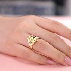 a woman's hand with a gold ring on it