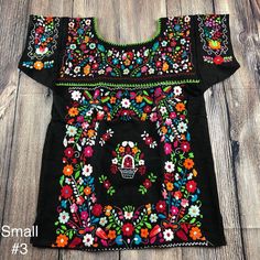 "Armpit to armpit 17\" Armhole 8\" Long 26\" Best fits Small may fit Median Completely handmade by Mexican artisans Embroidered by hand. Ready to ship!" Black Cotton Tops With Intricate Embroidery, Folk Style Multicolor Top With Geometric Embroidery, Fitted Multicolor Floral Embroidered Top, Black Tops With Floral Embroidery For Festivals, Black Floral Embroidered Tops For Festivals, Folk Multicolor Embroidered Tops For Cinco De Mayo, Folk Style Multicolor Embroidered Top For Cinco De Mayo, Folk Style Multicolor Tops For Cinco De Mayo, Spring Folk Tops With Machine Embroidery