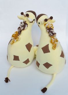 two stuffed giraffes sitting next to each other