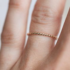 You can never have too many stackers! The Twist Ring is the loveliest solid gold rope you ever did see that is twisted into the perfect little ring. This ring wears beautifully included in a stack or by itself and makes for one of the daintiest and most versatile pieces you can dream up. As simple as the Twist Ring is, it can add just the right touch of flair to your stack and can bring the sweetness you've been looking for to your personal collection. Twisted Stackable Promise Rings, Yellow Gold Twisted Stackable Jewelry, Adjustable 14k Gold Twisted Ring, 14k Gold Twisted Rings For Gift, 14k Gold Twisted Promise Ring, Adjustable Twisted 14k Gold Rings, Minimalist Twisted Yellow Gold Ring, Twisted 14k Yellow Gold Stackable Rings, Dainty Twisted Yellow Gold Jewelry