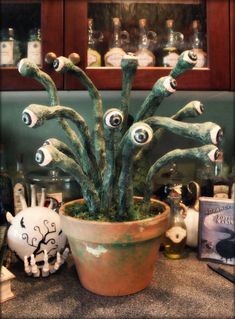 a potted plant with googly eyes on it