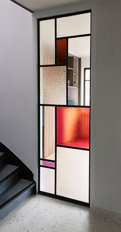 an open door with multiple colored glass panels on it