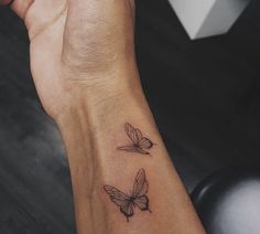 two small butterflies on the wrist tattoo design for women's wrists and hand area