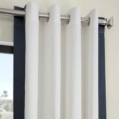 white and black curtains hanging in front of a window