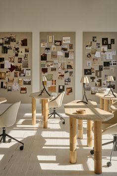 several chairs and tables in an office with pictures on the wall