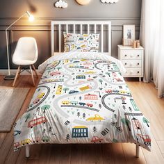 a child's bed with cars and trucks printed on the comforter, next to a white chair