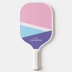 a pink, blue and white paddle with the name family ericson written on it