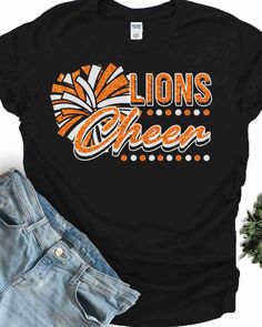 Looking for a unique and high-quality heat transfer design for your Lions? Look no further than the Lions DTF Transfer! Crafted from top-quality materials, this heat transfer design is sure to stand up to even the toughest wear and tear. Whether you're cheering on your team from the sidelines or hitting the town with friends, this DTF transfer is sure to turn heads and show off your school spirit. Whether you're looking for school spirit designs, sports team transfers, or something entirely uniq Black Cotton T-shirt With Glitter Print, Black Glitter T-shirt With Short Sleeves, Black Glitter Short Sleeve T-shirt, Trendy Black T-shirt With Glitter Print, Trendy Black Glitter Tops, Black Glitter Print Tops For Cheerleading, Black Glitter Print T-shirt For Cheerleading, Cheer Pom Poms, From The Sidelines