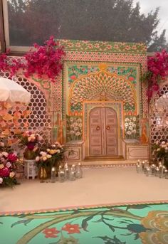 an elaborately decorated stage with flowers and candles