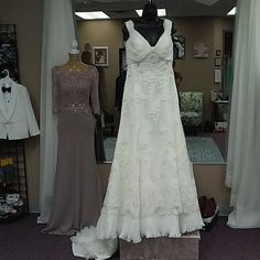 wedding gowns are displayed on mannequins in a store