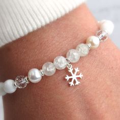 All winter long our silver snowflake bracelet will add a touch of elegance to your outfits. You'll love the dainty snowflake charm and classy beaded design. This bracelet will never go out of style and makes a perfect Christmas gift! ABOUT: * Materials: sterling sliver lobster claw and sterling silver 1.5 inch extension * Beads: freshwater pearl, white shell, glass, quartzite, sterling beads * Width: 6mm SHOP OUR BRAND > https://rosaperlina.etsy.com WHAT IS STERLING SILVER? * Sterling silver is White Holiday Jewelry For Festive Occasions, White Christmas Jewelry For Holidays, White Jewelry For Winter Holiday, Elegant Festive Jewelry For Winter, Silver Holiday Bracelet, Silver Bracelet For Holiday, Silver Bracelets For Holiday, Elegant White Christmas Jewelry, Elegant White Jewelry For Christmas