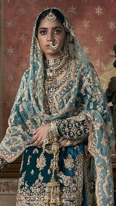 a woman in a blue and gold bridal outfit