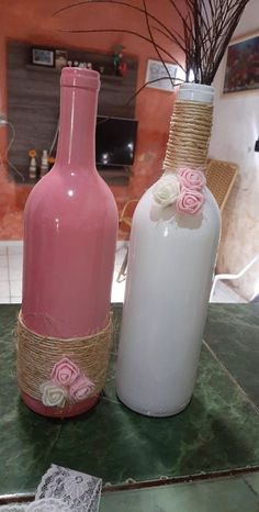 two pink and white vases sitting on top of a table