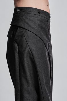 "Drop Crotch Trouser with Asymmetrical Front Closure__ // EXPRESS DELIVERY ONLY __Elastic Backside Waistband with Belt __2 Front Pockets __2 Rear Pockets __Asymmetrical Hidden Front Closure __Lightweight Wool Fabric model__ bust 92 (36\"), waist 72 (28\"), hips 102 (40\"), biceps 28 (11''), height 177 (5'8\"), kg 65 (143 lbs) model wears size M | color: dark grey fabric__ 100 wool care__ dry clean sizing__ size XS (US 4, EU 34, IT 40, UK 8) bust: 79-84 cm / 31\"-33\" waist: 60-65 cm / 23.5\"-25. Elegant Asymmetrical Bottoms With Pockets, Workwear Bottoms With Belt Loops And Asymmetrical Hem, Asymmetrical Hem Bottoms With Belt Loops For Work, Asymmetrical Skirt With Belt Loops For Work, Avant-garde Fitted Asymmetrical Skirt, Avant-garde Fitted Bottoms With Pockets, Avant-garde Fitted Pants With Pockets, Fitted Asymmetrical Avant-garde Bottoms, Avant-garde Fitted Asymmetrical Bottoms