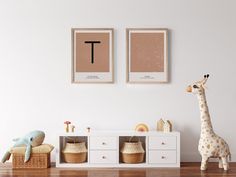 two pictures hang on the wall next to a toy giraffe