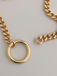 This is a high quality thick, brass, gold plated chain necklace. Minimalist and modern chunky gold curb link chain necklace with a decorative spring lock connector. The curb/cuban link necklace is is a show stopping design and is a weighty brass necklace with 14k gold plating. Lead safe and Nickel safe. You have the option of adding your own pendant or enhancer to the connector. So Versatile ! Please note that the length ordered includes the size of the spring lock connector. The chain is 9mm wi Metal Chain Ring With Gold Link Chain, Metal Chain Ring With Link Shape, Gold Metal Chain Link Ring, Gold Chain Link Ring Made Of Metal, Curb Chain Link Necklace, Metal Cuban Link Chain Necklace With Lobster Clasp, Metal Curb Chain Necklace, Yellow Gold Metal Chain Necklace With Curb Chain, Chunky Cuban Link Metal Necklace