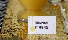 a close up of a table with silverware and a sign on it that says champagne citrus fizz