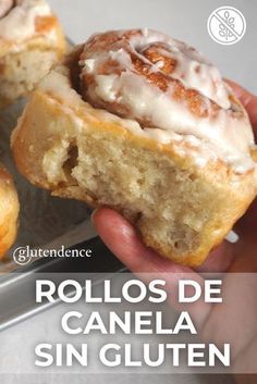 a person holding up a cinnamon roll in front of the camera and text reads rollos de canela sin gluten