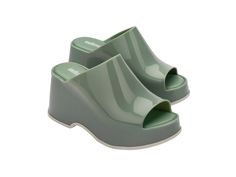 Throwback style meets current trends—that’s just how the Patty rolls. Lightweight and streamlined with a wide strap and a peep toe, these platform mules are true attention seekers, and the contrasting sole detail amps up the cool factor. Made from our revolutionary Melflex® PVC plastic, you enjoy more flexibility and comfort. Plus, they’re 100% recyclable. Chic Platform Slide Slippers, Trendy Closed Toe Platform Slippers, Trendy Platform Slip-on Slides, Modern Open Toe Platform Slippers For Spring, Trendy Green Open-heel Mules, Modern Closed Toe Platform Slippers For Spring, Chic Platform Slides With Round Toe, Trendy Open Toe Slides With Padded Heel, Modern Slides With Padded Heel For Summer