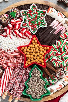 a platter filled with lots of different types of candy canes and candies