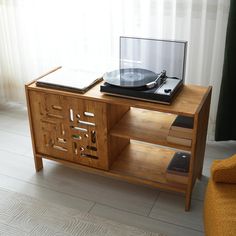 a record player sitting on top of a wooden cabinet