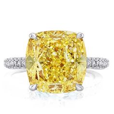 a fancy yellow diamond ring with diamonds around it