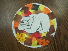 a paper plate with an image of a polar bear on it and leaves around it