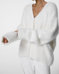 Color: White Midweight knit fabric Regular fit V neck  Drop shoulders Front button closure Unlined 48% Polyamide 33% Angora 19% Wool Hand Wash in Cold Water Product Measurements: ONE SIZE  Shoulder 19cm / 7.48in,   Bust 139cm / 54.75in Length 74cm / 29.13in,   Sleeve length 61cm / 24in Cheap Embroidered White Cardigan, Oversized White Cardigan, Angora Cardigan, Fluffy Cardigan, Winter Knitwear, Oversized Knit Cardigan, Cardigan White, Oversize Knit, Cardigan Women