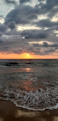 the sun is setting over the ocean with clouds in the sky and waves on the beach