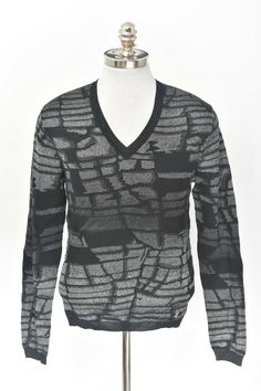 Description: Tag Size:  48 (EU) Medium (US) Material:  73% Cotton 19% Viscose 11% Polyester 1% Elastane  Color:  Black and Platinum  Features: Long Sleeve V-Neck Sweater Smooth Medium Weight Fabric Unique Brick Design  Ribbed Sleeve Cuffs, Waist,  and Collar Versace Logo on Front of Sweater Made in Italy  Measurements: Length (From Bottom of Collar): 26.00" Sleeves: 27.25" Chest: 39.00" Shoulders: 17.00" Designer V-neck Tops For Fall, Designer Black Sweater For Fall, Designer V-neck Sweater For Work, Designer Black Workwear Sweater, Luxury V-neck Sweater With Pockets, Black Fitted Designer Sweater, Designer Black Fitted Sweater, Luxury Fitted Long Sleeve V-neck Sweater, Luxury Long Sleeve Knit V-neck Sweater