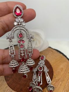 AD Wine Red Chandelier Silver Polish EarringsColor : Diamond FinishSize : Approx 3.5 Inches; Weight Approx 17 Gms EachStones : American Diamond Wine Red Stone Festive Red Chandbali Chandelier Earrings, Traditional Red Dangle Chandelier Earrings, Traditional Red Handmade Chandelier Earrings, Red Crystal Dangle Chandelier Earrings, Luxury Traditional Red Chandelier Earrings, Chandelier Silver, Ad Earrings, Red Chandelier, Silver Polish