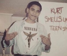 an old black and white photo of a young man holding his hands up in front of him