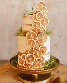 a three tiered cake with orange slices on it