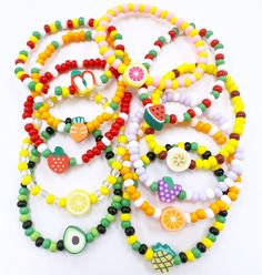 a bunch of bracelets that have fruit on them